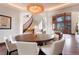 Well-lit dining area with decorative chandelier, hardwood floors, and comfortable seating at 651 Ruby Trust Dr, Castle Rock, CO 80108