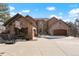 Beautiful two-story stone home featuring a spacious driveway and three-car garage at 651 Ruby Trust Dr, Castle Rock, CO 80108