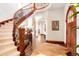 Bright foyer with winding staircase, hardwood floors, and arched doorways at 651 Ruby Trust Dr, Castle Rock, CO 80108