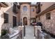 Charming stone front entrance with courtyard, wrought iron gate, and cozy seating area at 651 Ruby Trust Dr, Castle Rock, CO 80108