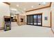 Large game room with a fireplace, an arcade game, a piano and sliding doors to the outside at 651 Ruby Trust Dr, Castle Rock, CO 80108
