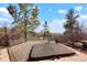 Secluded hot tub area on a deck surrounded by lush greenery with scenic views at 651 Ruby Trust Dr, Castle Rock, CO 80108