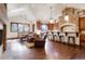 Open-concept kitchen with breakfast bar, stone detailing, and hardwood floors at 651 Ruby Trust Dr, Castle Rock, CO 80108