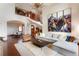 Expansive living room with vaulted ceiling, stone fireplace, and open dining area at 651 Ruby Trust Dr, Castle Rock, CO 80108