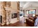 Comfortable living area features a stone fireplace, hardwood floors, and ample seating at 651 Ruby Trust Dr, Castle Rock, CO 80108