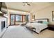 Spacious main bedroom with fireplace, vaulted ceiling, and private balcony at 651 Ruby Trust Dr, Castle Rock, CO 80108