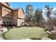 Private putting green next to a home with mature trees and landscaping for the golf enthusiast at 651 Ruby Trust Dr, Castle Rock, CO 80108