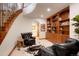 Cozy sitting room with hardwood bookshelf, wood trim, and a spiral staircase at 651 Ruby Trust Dr, Castle Rock, CO 80108