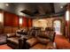 Spacious theater room featuring comfortable leather seating, a projector and a stone archway at 651 Ruby Trust Dr, Castle Rock, CO 80108
