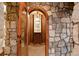 View of the wine cellar featuring a stone archway and shelving, illuminated by modern lighting at 651 Ruby Trust Dr, Castle Rock, CO 80108