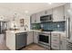 Modern kitchen with stainless steel appliances and blue tile backsplash at 100 Park W Ave # 604, Denver, CO 80205