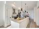Open kitchen design with granite countertops, stainless steel appliances, and a modern island with pendant lighting at 15276 W 69Th Pl, Arvada, CO 80007