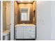 Updated bathroom with a modern vanity and wood-paneled walls at 2314 S Troy St, Aurora, CO 80014