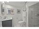 Modern bathroom with shower, gray tile, neutral paint, and stylish fixtures at 2461 Depew St, Edgewater, CO 80214