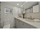 Bathroom featuring a double vanity, decorative tile, neutral paint, and modern fixtures at 2461 Depew St, Edgewater, CO 80214