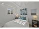 Bright bedroom featuring neutral paint, natural light, comfortable bed and tasteful decor at 2461 Depew St, Edgewater, CO 80214