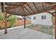 Outdoor patio featuring a wood pergola, manicured lawn, modern home, and wood accents at 2461 Depew St, Edgewater, CO 80214