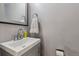 Stylish half bath with a modern vanity, mirror, and neutral color scheme creating a clean and fresh look at 9195 E Lehigh Ave # 162, Denver, CO 80237