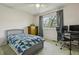 Inviting bedroom with a large window, ceiling fan, desk and cozy decor providing a comfortable space at 9195 E Lehigh Ave # 162, Denver, CO 80237