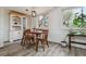 Charming dining area with classic wooden table and chairs, complemented by natural lighting at 9195 E Lehigh Ave # 162, Denver, CO 80237