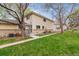 Inviting townhome with brick facade, landscaped yard, and a quaint front entrance at 9195 E Lehigh Ave # 162, Denver, CO 80237