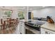 Bright kitchen showcases stainless steel appliances, quartz counters, eat-in area, and seamless flow into the living space at 9195 E Lehigh Ave # 162, Denver, CO 80237
