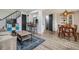 Cozy living room with hardwood floors, modern furnishings, and seamless transition to dining area at 9195 E Lehigh Ave # 162, Denver, CO 80237