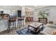 Bright living area flowing into a cozy dining space, featuring modern decor and ample natural light at 9195 E Lehigh Ave # 162, Denver, CO 80237