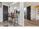 Open-concept living space with breakfast bar seating that extends into the kitchen area at 9195 E Lehigh Ave # 162, Denver, CO 80237