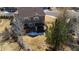 Aerial view of a backyard with a pergola covered hot tub, a privacy fence and mature trees at 4765 Larksong Dr, Castle Rock, CO 80109