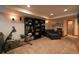 Finished basement featuring a seating area, built-in bookshelves, and recreational equipment at 4765 Larksong Dr, Castle Rock, CO 80109