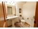 Cozy bathroom features a pedestal sink, wood accents, and decorative wall art at 4765 Larksong Dr, Castle Rock, CO 80109