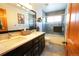 Modern bathroom featuring double sinks, dark cabinetry and tiled shower at 4765 Larksong Dr, Castle Rock, CO 80109