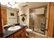 Updated bathroom with a glass-enclosed shower, modern fixtures, and ample storage at 4765 Larksong Dr, Castle Rock, CO 80109