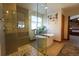 Elegant bathroom featuring a glass-enclosed shower, soaking tub, and stylish fixtures for a spa-like experience at 4765 Larksong Dr, Castle Rock, CO 80109