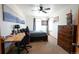 Spacious bedroom with carpet, ceiling fan, two windows, dresser, and desk at 4765 Larksong Dr, Castle Rock, CO 80109