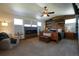 Spacious main bedroom with rustic wood accent wall, fireplace, large windows, and cozy furnishings at 4765 Larksong Dr, Castle Rock, CO 80109