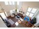 Open concept living room boasts soaring ceilings, large windows, and modern furnishings at 4765 Larksong Dr, Castle Rock, CO 80109