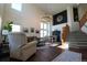 Bright living room boasts soaring ceilings, large windows, hardwood floors, and staircase at 4765 Larksong Dr, Castle Rock, CO 80109