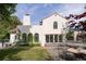 Home's backyard featuring a patio, manicured lawn, and architectural details of the house at 5800 E 6Th Avenue Pkwy, Denver, CO 80220
