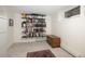 Finished basement area with shelving, window, and plush carpeting at 5800 E 6Th Avenue Pkwy, Denver, CO 80220