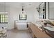 Elegant bathroom featuring a freestanding tub, dual sinks with marble counters, and modern fixtures at 5800 E 6Th Avenue Pkwy, Denver, CO 80220