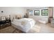 Bright bedroom with white accents, large windows, and neutral decor creating a serene and inviting space at 5800 E 6Th Avenue Pkwy, Denver, CO 80220
