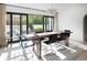 Bright dining room with large windows and doors, modern chandelier, and stylish wood table with seating for six at 5800 E 6Th Avenue Pkwy, Denver, CO 80220