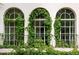 Exterior detail showcasing charming arched windows framed by climbing greenery at 5800 E 6Th Avenue Pkwy, Denver, CO 80220