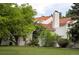 Home's exterior showcases lush landscaping and a red tile roof at 5800 E 6Th Avenue Pkwy, Denver, CO 80220