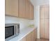 Kitchen with stainless steel microwave, ample countertop space, and wood cabinets at 5800 E 6Th Avenue Pkwy, Denver, CO 80220