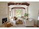 Inviting living room boasts vaulted ceilings, exposed beams, fireplace and a large arched window at 5800 E 6Th Avenue Pkwy, Denver, CO 80220