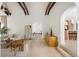 Open living room with beamed ceilings, modern decor, and easy access to kitchen at 5800 E 6Th Avenue Pkwy, Denver, CO 80220