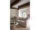 Comfortable living room features a neutral sectional sofa, light wood ceiling beams, and a round coffee table at 5800 E 6Th Avenue Pkwy, Denver, CO 80220